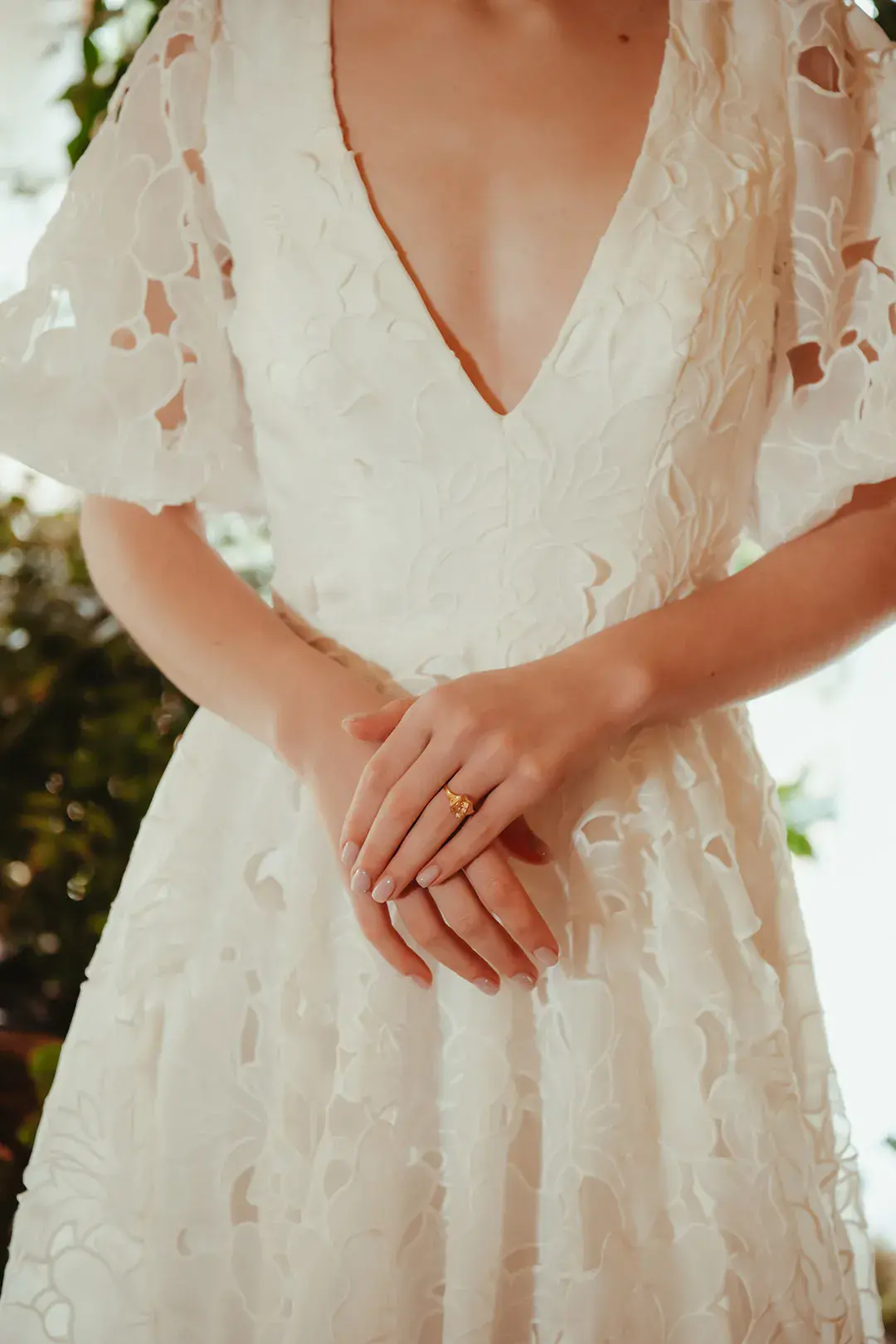 Bride in floral lace wedding dress with short sleeves and plunging neckline 