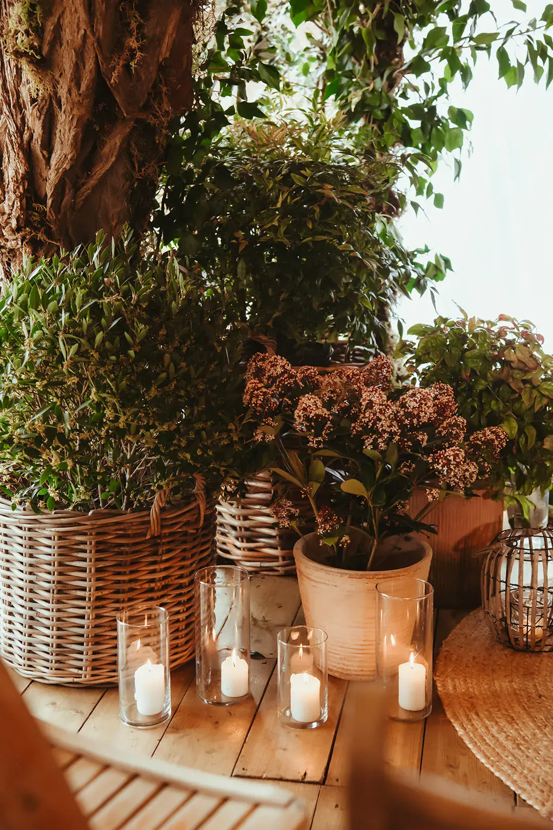 Mini pillar candles in hurricane vases with plant decorations for eco-friendly botanical wedding 