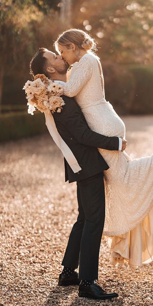 Bride and groom share a passionate and romantic kiss
