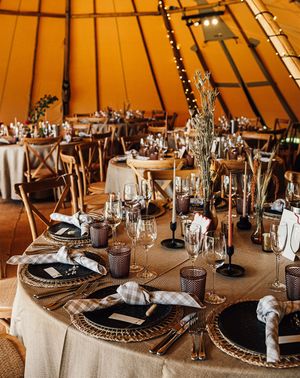 Tipi wedding with neutral wedding table decor and tablescape with warm lighting