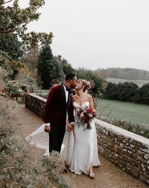 winter wedding at Berkeley Castle with red wedding suit jacket