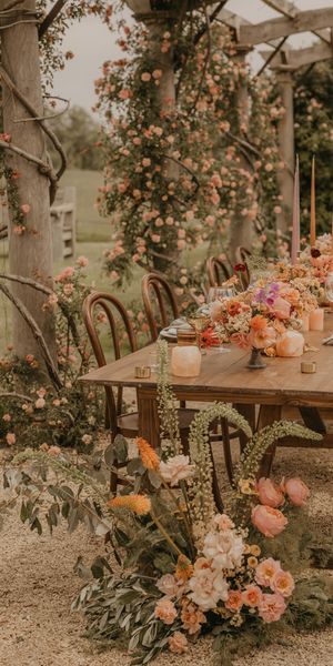 Summer wedding inspiration at Euridge Manor with orange, coral and peach wedding flowers and decor, and with Made With Love dresses