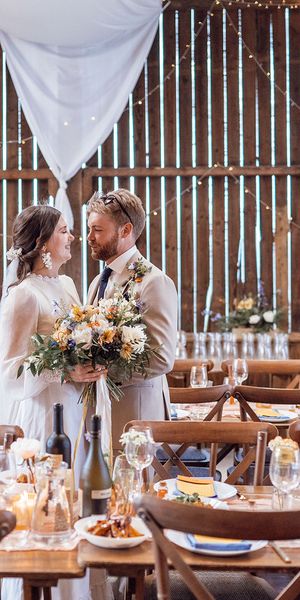 Bride and groom stand together at Deepdale Farm wedding venue for their DIY wedding,