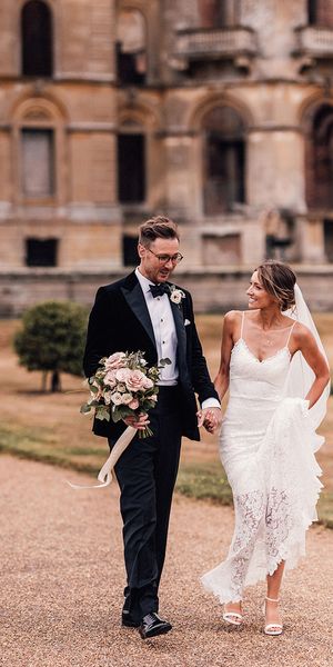 Bride in lace wedding dress and groom in black tuxedo for Hanley Hall Worcestershire wedding.