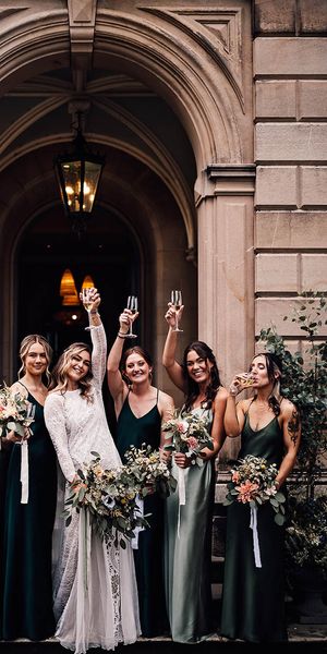 Bride with her bridesmaids in green bridesmaid dresses outside of Callow Hall.