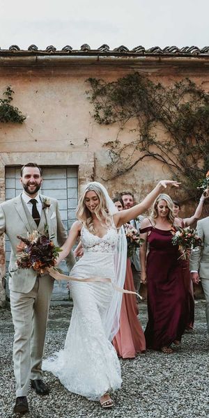 Tuscany destination wedding with lace wedding dress, tambourine favours and terracotta orange bridesmaid dresses