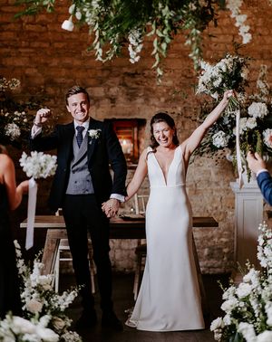 bride and groom exit form their ceremony at their barn wedding