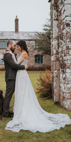 Bride in celestial and sparkly Zavana Couture wedding dress for rustic wedding. 