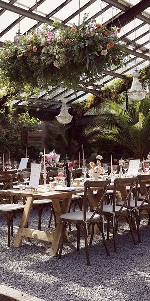 Anran wedding venue with hanging flower installations and chandeliers.