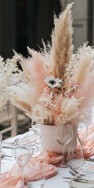 Pink and white pampas grass centrepiece decor for boho wedding.