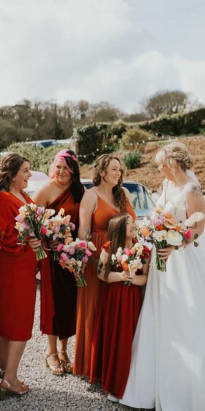 Tregedna Lodge wedding with bridesmaids in orange bridesmaid dresses.