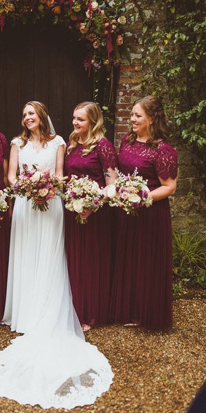 Ramster Hall wedding with bride and bridesmaids in dark red dresses