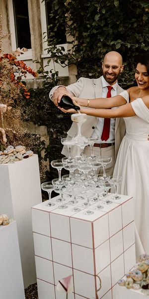 Bride and groom pour their champagne tower for their wedding at Chapel House Estate.