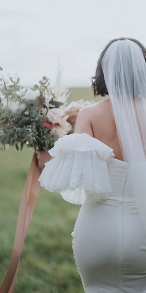 Bride in a fitted Emmy Mae Bridal gown with fun sleeves!