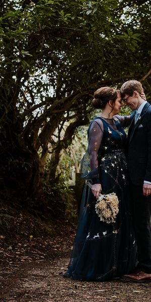 Bride in a bespoke navy blue wedding dress for celestial theme wedding.