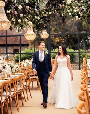 Bride in Phillipa Lepley applique wedding dress with groom for glass marquee wedding reception.