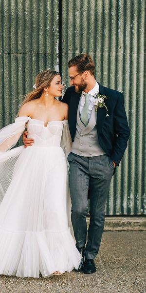 Bride in tulle wedding dress by Alena Leena Bridal with groom. 