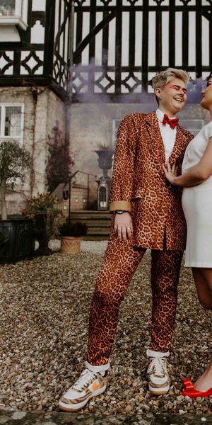 Pink and orange fun, retro LGBTQ+ wedding inspiration with roller skates, disco balls and a tulip bouquet by Lucy Dennis Photography