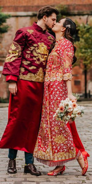 Bride and groom in traditional red and gold Chinese wedding attire for multicultural city wedding in Manchester