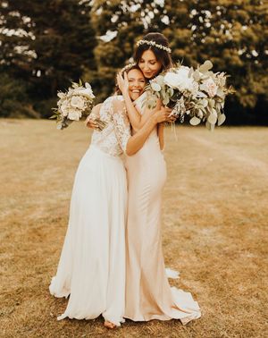 Bride and bridesmaid embracing as you can see the friendship between them
