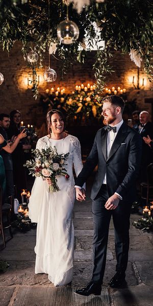 Bride in a long sleeve Atelier Pronovias wedding dress with the groom in black tie