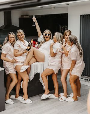 Bridal party wearing matching satin pjs for UK hen do