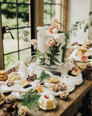 Vegan wedding inspiration with a dessert table and white iced wedding cake.
