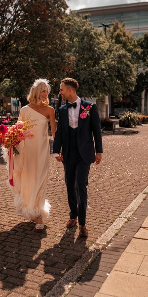 bride-in-cold-shoulder-feather-wedding-dress-with-groom-at-hackney-wedding