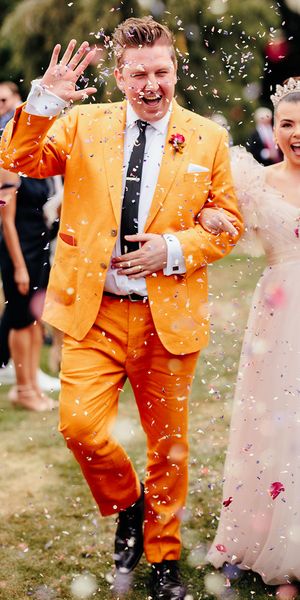 confetti moment at preston court wedding with pink wedding dress and yellow wedding suit