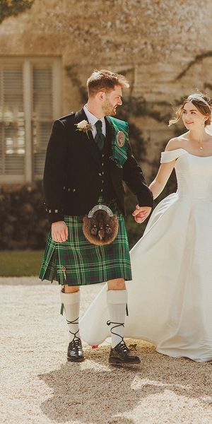 groom-in-green-kilt-with-bride-in-corset-off-the-shoulder-wedding-dress-at-luxe-country-house-wedding