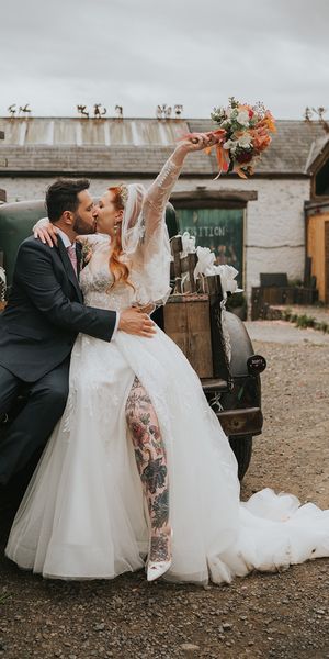 bride-and-groom-kiss-in-front-of-wedding-car-at-welsh-wedding