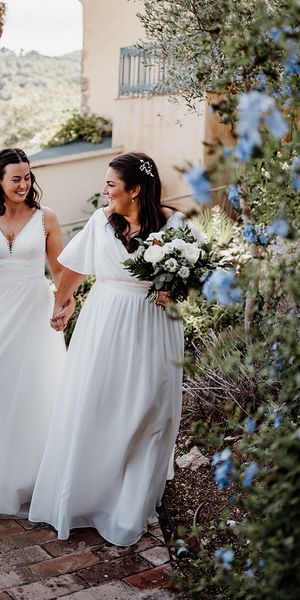 two-brides-wearing-floaty-wedding-dresses-at-destination-wedding
