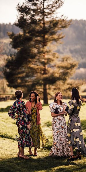 wedding guests wearing long sleeve floral wedding guest dresses for outdoor wedding