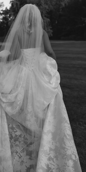 Bride wearing floral corset wedding dress with long train