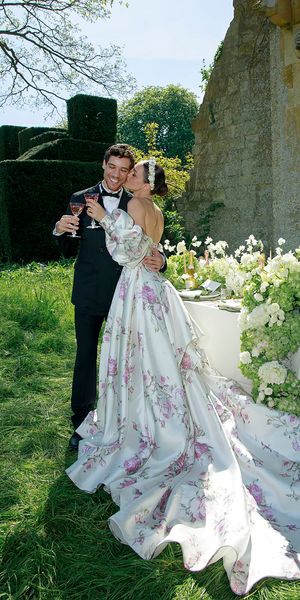 White spring wedding dress with train and pink floral pattern