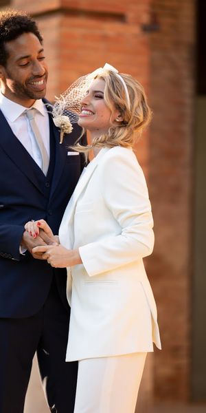 Couple wearing Hockerty and Sumissura custom bride and groom wedding suits