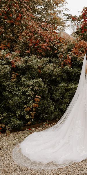 Bride in autumn wedding dress in autumn garden