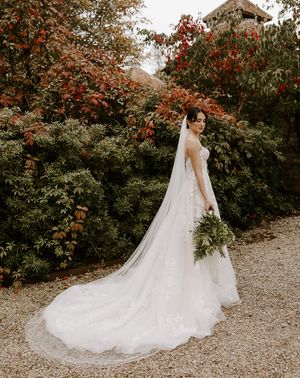 Bride in autumn wedding dress in autumn garden