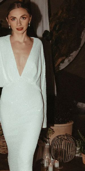 bride-wearing-deep-plunging-white-sequin-long-sleeve-reception-dress-Emma-Jane-Photography