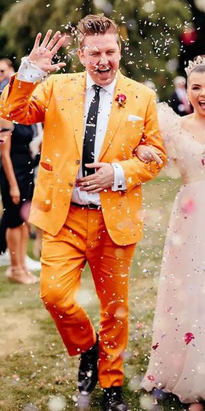 groom wearing colourful, unique mustard orange groom on wedding day