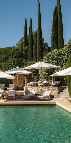 Pool area of luxury hotel in restored village in Provence for minimoon