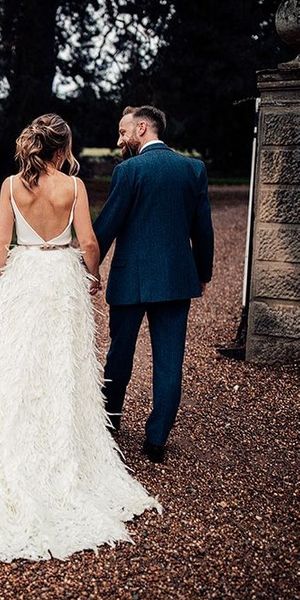 Charlie Brear Payton Bridal Gown & Piora Feather Skirt with Deep Red, Grasses & Pheasant Feather Floral Installation at Iscoyd Park, shot by Harry Michael