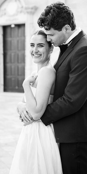 Black and white image of a bride and groom cuddling at a wedding in Puglia
