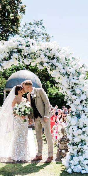 Elegant garden ceremony with soft florals and natural light, capturing a modern, romantic moment in an editorial style. Photo by Kate Izak Photography.