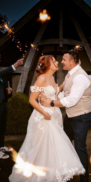 Bride and Groom enjoying their wedding day celebrating with their loved ones with sparklers. Photo by Vicky Lewis Photography