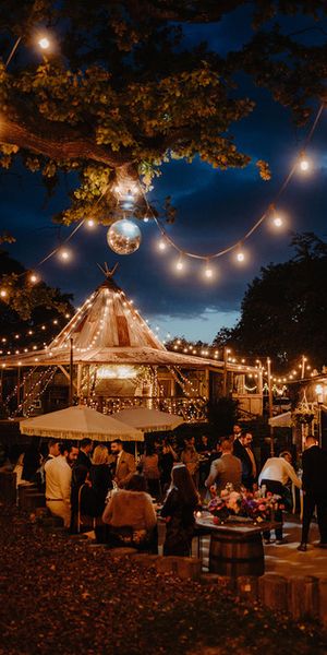 As the sun sets and your evening guests arrive, enjoy cocktails on the patio adorned with festoon lights and disco balls. Photo credit: Kit Myers