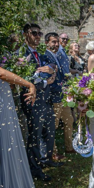 Alex & Nicola emerge from the church in a shower of confetti, hand in hand & beaming with pure joy. Nicola's stunning bouquet of purple lisianthus, blush roses & lush greenery perfectly complemented the warm summer sunshine as their guests cheered them on. 