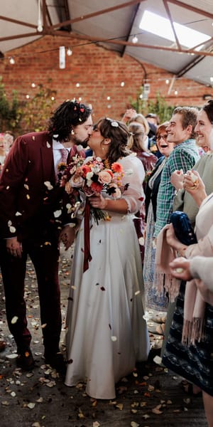 Bride and groom walk down the aisle with fresh petal confetti at moat hall barns. 