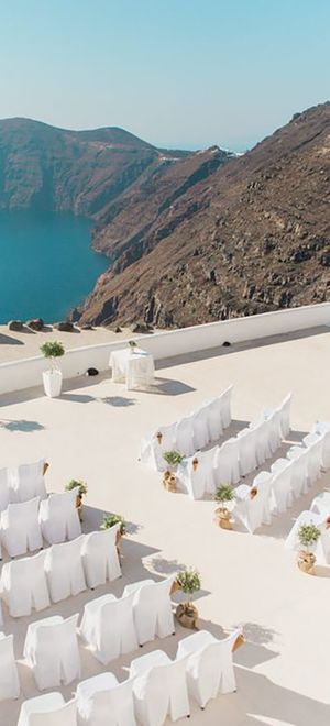 santorini wedding destination venue, ceremony area with chairs by the sea