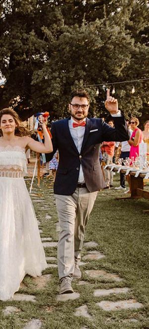 Greece destination wedding with strapless lace boho weddng dress, pampas grass decor, wool rugs & goat table plan by WedPashalis Photography